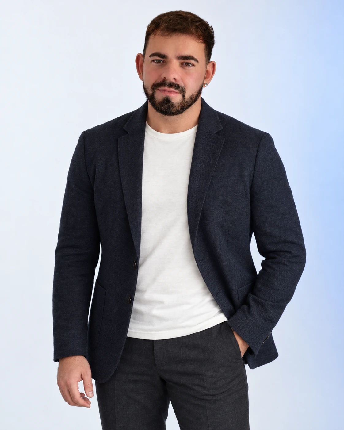 James Tandy standing in a relaxed navy jacket and white T-shirt.
